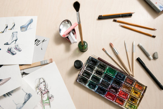 Designer workplace with painting tools. Art illustration of fashion sketches