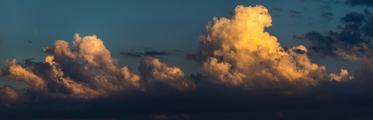 Cumulus clouds on sunset sky.