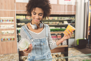 Joyful young woman is selecting meal
