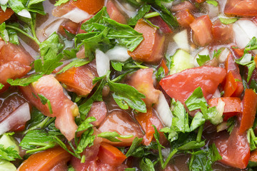 Shepherd salad mixed with minced onions tomatoes, peppers, cucumbers and seasoned with olive oil and lemon juice. Turkish Coban salata