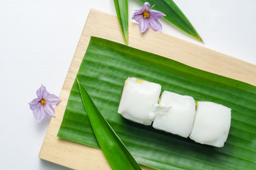 Thai jelly with coconut cream on green banana leaf.