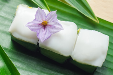 Thai jelly with coconut cream on green banana leaf.