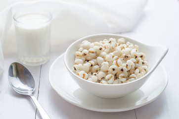 Healthy breakfast with boiled job's tears porridge in white bowl on wooden table.