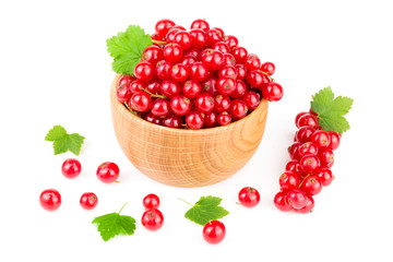 Red currant berries in a wooden bowl with leaf isolated on white background
