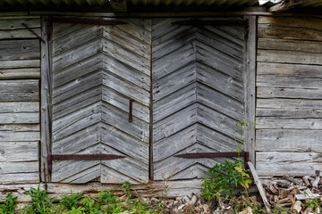 Doors of old abandoned wooden barn in the countryside of Latvia