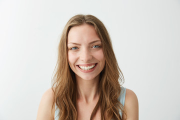 Naklejka premium Beautiful sincere happy girl smiling laughing looking at camera over white background.