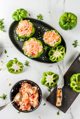 Autumn recipes. Home stuffed bell pepper with minced meat, carrots, tomatoes, herbs and cheese. Cooking process. On a white marble table. Top view. Copy space