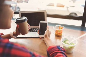 Charming young woman is typing message using mobile phone