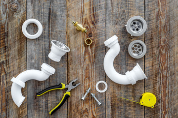 Clear clogged sink drains. Parts and tools on wooden background top view