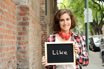 Woman holding chalkboard with "Like".