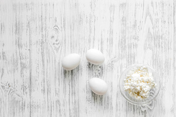 Farm dairy products. Cottage, eggs on light wooden background top view copyspace