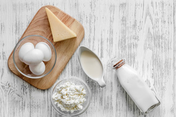 Natural food. Milk, cottage, cheese and eggs on light wooden background top view copyspace