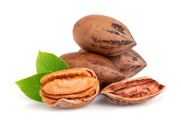 heap of pecan with leaves isolated on white background