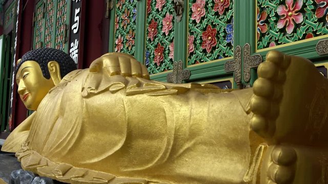 Busan, South Korea-02 July, 2017: 4K Entrance of Daegaksa a Buddhist temple of the Jogye Order in Busan. The golden Amita-bul lying on the main altar, Buddha of the Western Paradise. South Korea.-Dan