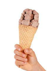 chocolate ice cream in a waffle horn in the hand isolated