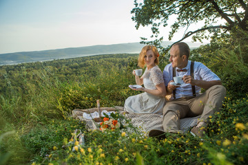 Attractive Couple Enjoying Romantic Sunset Picnic in the Countryside