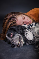 Dog, an english setter, and its owner, a beautiful caucasian woman, playing together