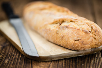Fresh baked Baguette on wooden background (selective focus)