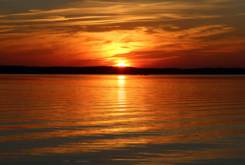 Naklejka na ściany i meble beautiful orange sunset on the lake