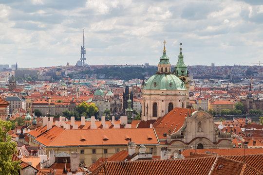 Scenic view of the St. Nicholas Church, other old buildings at the Mala Strana District (Lesser Town) and beyond in Prague, Czech Republic. Viewed slightly from above in the daytime.