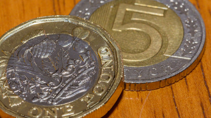British Pound Coin on top of 5 Polish Zloty B