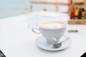 White cup of hot aromatic coffee