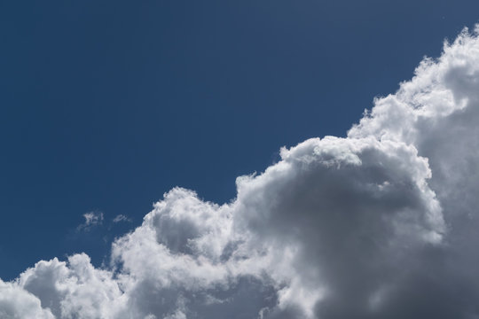 The sky is divided diagonally Cumulus clouds and clear sky.