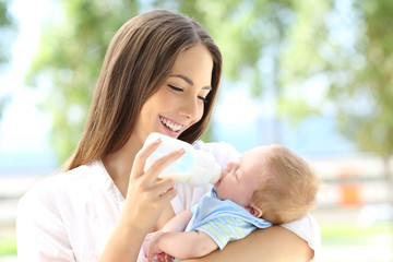 Mother giving bottle feeding to her baby