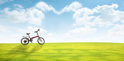 Bicycle on Green Grass Sky background