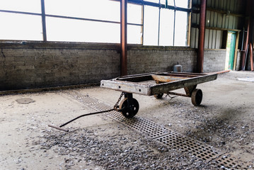 Old wooden hand cart trolley in a warehouse