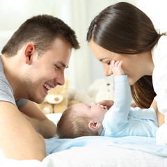 Baby playing with his parents