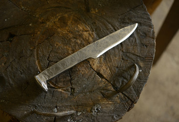 Hand forged steel knife made from railroad spike in blacksmith shop