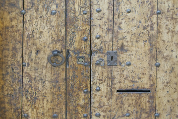 Old wooden door with metal elements