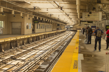 Waiting for light rail train on tracks for travel and transit concept.