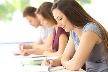 Fototapeta premium Students studying taking notes at classroom