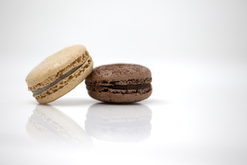 Light brown macaron with a dark brown macaron