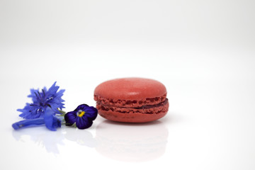 Red macaron with edible flowers