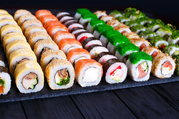Great assortment of tasty multicolored maki sushi rolls, selective focus. Sushi restaurant concept