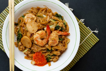 Stir fried flat rice noodle or char kway teow that is famous among Indonesian, Malaysian and Singaporean as breakfast or another meal