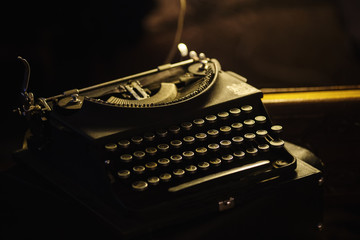 Vintage typewriter in dramatic lighting, Low-key image, Selective focus