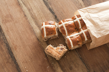 Brown paper packet with fresh hot cross buns