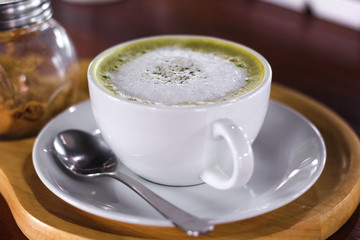 Hot matcha green tea latte glass with milk