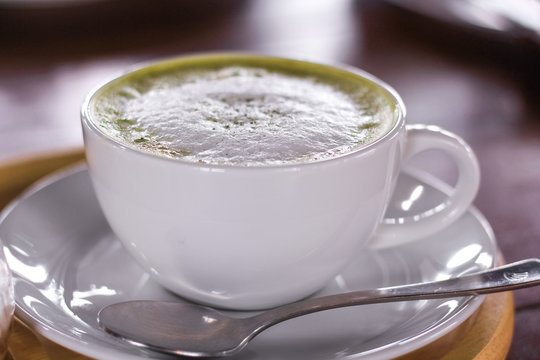 Hot matcha green tea latte glass with milk