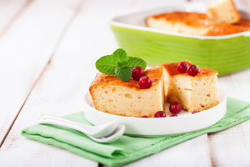 Cottage cheese casserole on a light background. Selective focus. Copy space
