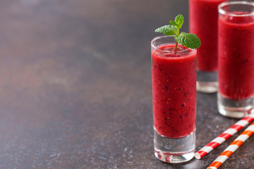 Strawberry smoothies in a glass on a dark  background. Selective focus. Copy space