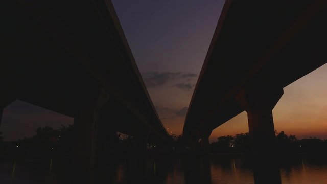 under the bridge from dusk to night time lapse shot