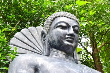 Close-Up View of Stone-Carved Black Buddha Statue in Kushinagar