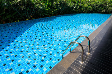 blue swimming pool around with green nature garden