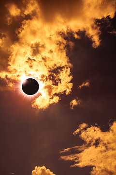 Scientific natural phenomenon. Total solar eclipse with diamond ring effect glowing on sky.