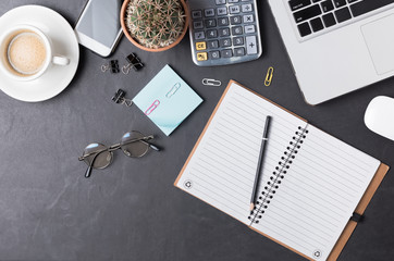 Blank notebook with pencil on office black desk table